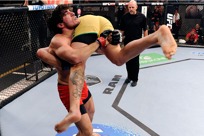 LACHUTE, CANADA - DECEMBER 6:  (L-R) Team Canada fighter Elias Theodorou takes down Team Australia fighter Tyler Manawaroa in their semifinal middleweight fight during filming of The Ultimate Fighter Nations television series on December 6, 2013 in Lachut