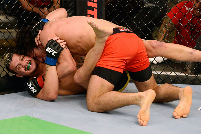 LACHUTE, CANADA - DECEMBER 6:  (R-L) Team Canada fighter Elias Theodorou controls the body of Team Australia fighter Tyler Manawaroa in their semifinal middleweight fight during filming of The Ultimate Fighter Nations television series on December 6, 2013