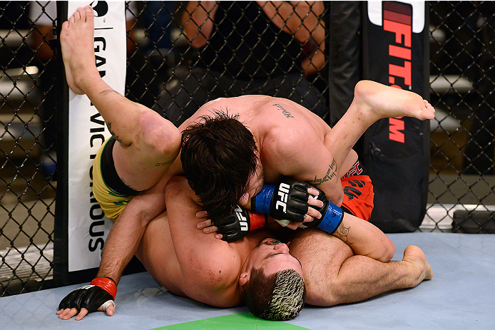 LACHUTE, CANADA - DECEMBER 6:  (R-L) Team Canada fighter Elias Theodorou controls the body of Team Australia fighter Tyler Manawaroa in their semifinal middleweight fight during filming of The Ultimate Fighter Nations television series on December 6, 2013