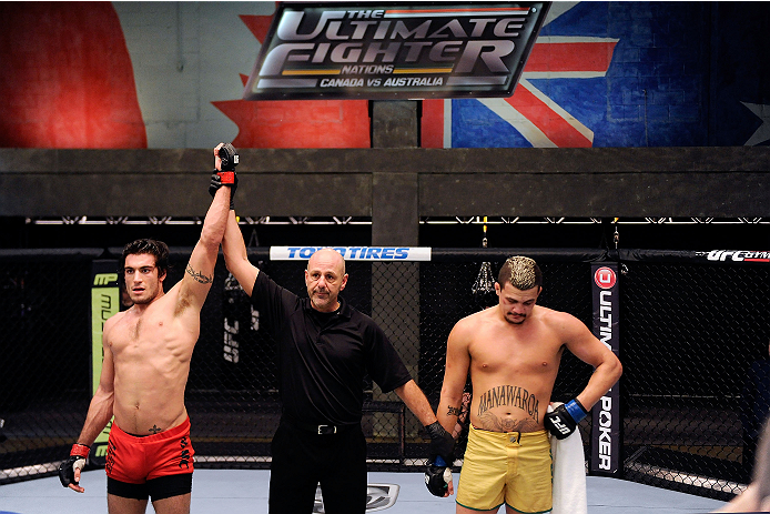 LACHUTE, CANADA - DECEMBER 6:  (L-R) Team Canada fighter Elias Theodorou celebrates after defeating Team Australia fighter Tyler Manawaroa in their semifinal middleweight fight during filming of The Ultimate Fighter Nations television series on December 6