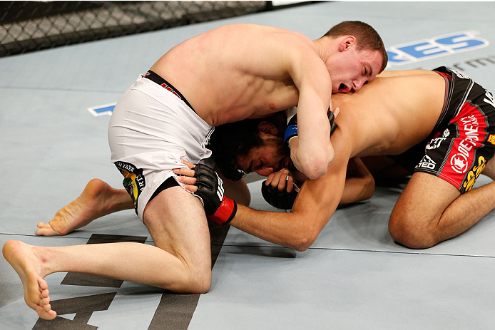 BOSTON, MA - AUGUST 17: (L-R) James Vick secures a guillotine choke submission against Ramsey Nijem in their UFC lightweight bout at TD Garden on August 17, 2013 in Boston, Massachusetts. (Photo by Josh Hedges/Zuffa LLC/Zuffa LLC via Getty Images)