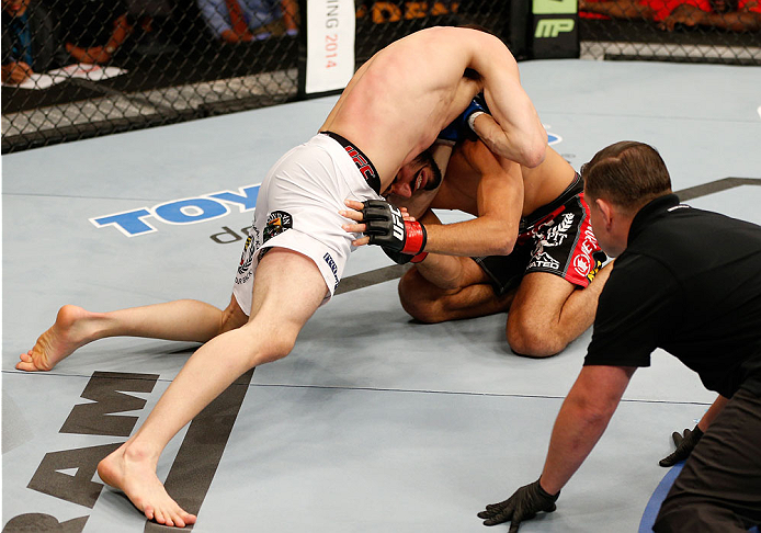 BOSTON, MA - AUGUST 17: (L-R) James Vick secures a guillotine choke submission against Ramsey Nijem in their UFC lightweight bout at TD Garden on August 17, 2013 in Boston, Massachusetts. (Photo by Josh Hedges/Zuffa LLC/Zuffa LLC via Getty Images)