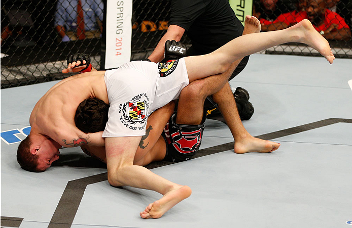 BOSTON, MA - AUGUST 17: (L-R) James Vick secures a guillotine choke submission against Ramsey Nijem in their UFC lightweight bout at TD Garden on August 17, 2013 in Boston, Massachusetts. (Photo by Josh Hedges/Zuffa LLC/Zuffa LLC via Getty Images)