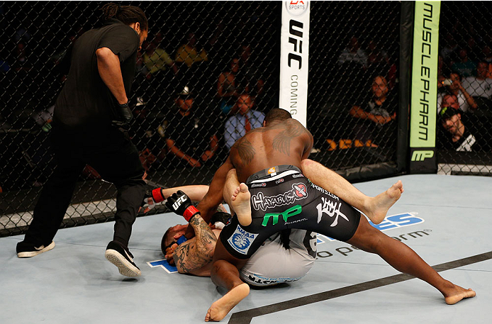 BOSTON, MA - AUGUST 17: (R-L) Ovince Saint Preux punches Cody Donovan as referee Herb Dean moves in to stop the bout in their UFC light heavyweight bout at TD Garden on August 17, 2013 in Boston, Massachusetts. (Photo by Josh Hedges/Zuffa LLC/Zuffa LLC v