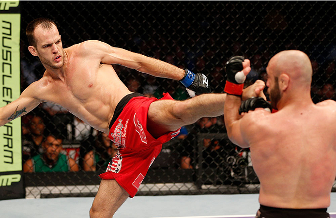 BOSTON, MA - AUGUST 17:  (L-R) Cole Miller kicks Manny Gamburyan in their UFC featherweight bout at TD Garden on August 17, 2013 in Boston, Massachusetts. (Photo by Josh Hedges/Zuffa LLC/Zuffa LLC via Getty Images)