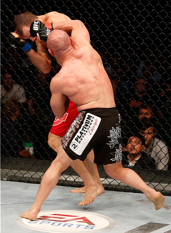 BOSTON, MA - AUGUST 17:  (R-L) Manny Gamburyan punches Cole Miller in their UFC featherweight bout at TD Garden on August 17, 2013 in Boston, Massachusetts. (Photo by Josh Hedges/Zuffa LLC/Zuffa LLC via Getty Images)