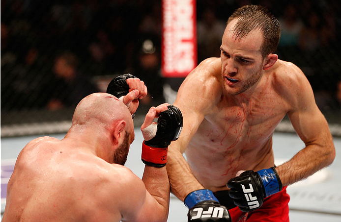 BOSTON, MA - AUGUST 17: (R-L) Cole Miller punches Manny Gamburyan in their UFC featherweight bout at TD Garden on August 17, 2013 in Boston, Massachusetts. (Photo by Josh Hedges/Zuffa LLC/Zuffa LLC via Getty Images)