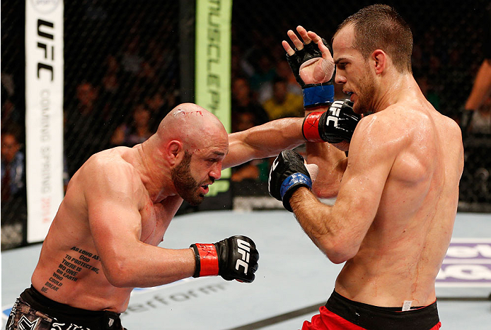 BOSTON, MA - AUGUST 17: (L-R) Manny Gamburyan punches Cole Miller in their UFC featherweight bout at TD Garden on August 17, 2013 in Boston, Massachusetts. (Photo by Josh Hedges/Zuffa LLC/Zuffa LLC via Getty Images)