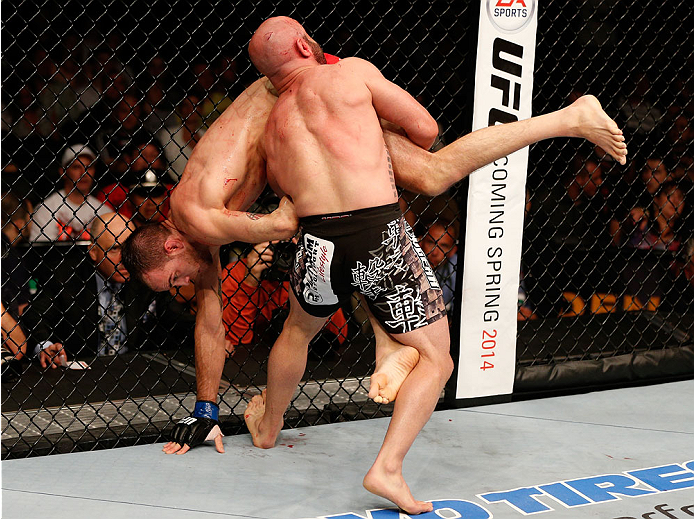 BOSTON, MA - AUGUST 17:  (R-L) Manny Gamburyan takes down Cole Miller in their UFC featherweight bout at TD Garden on August 17, 2013 in Boston, Massachusetts. (Photo by Josh Hedges/Zuffa LLC/Zuffa LLC via Getty Images)