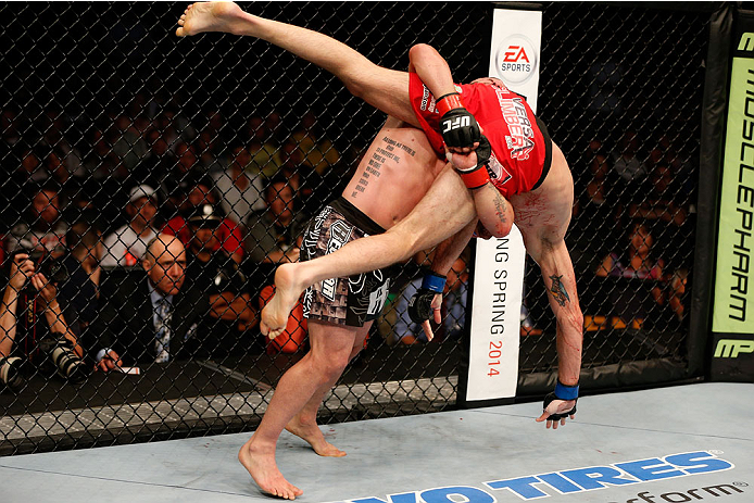 BOSTON, MA - AUGUST 17:  (L-R) Manny Gamburyan takes down Cole Miller in their UFC featherweight bout at TD Garden on August 17, 2013 in Boston, Massachusetts. (Photo by Josh Hedges/Zuffa LLC/Zuffa LLC via Getty Images)