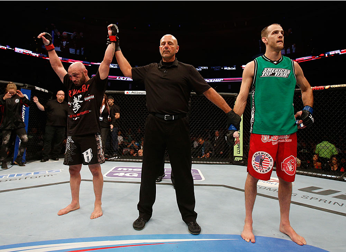 BOSTON, MA - AUGUST 17:  Manny Gamburyan (L) reacts after his decision victory over Cole Miller (R) in their UFC featherweight bout at TD Garden on August 17, 2013 in Boston, Massachusetts. (Photo by Josh Hedges/Zuffa LLC/Zuffa LLC via Getty Images)