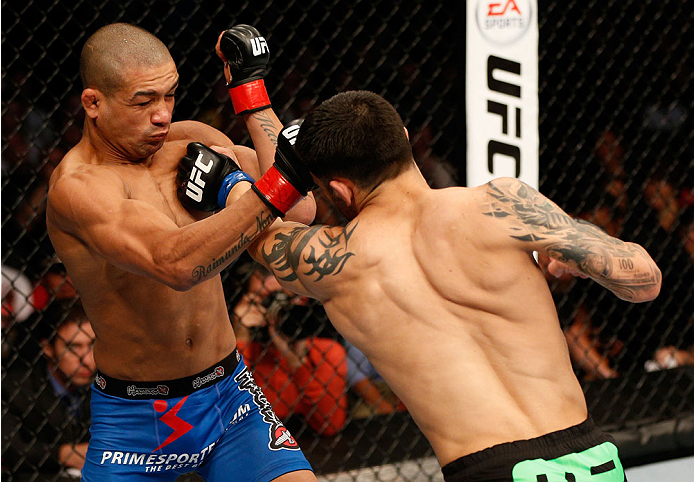 BOSTON, MA - AUGUST 17:  (R-L) Daniel Pineda punches Diego Brandao in their UFC featherweight bout at TD Garden on August 17, 2013 in Boston, Massachusetts. (Photo by Josh Hedges/Zuffa LLC/Zuffa LLC via Getty Images)