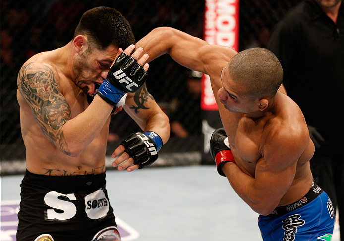 BOSTON, MA - AUGUST 17: (R-L) Diego Brandao punches Daniel Pineda in their UFC featherweight bout at TD Garden on August 17, 2013 in Boston, Massachusetts. (Photo by Josh Hedges/Zuffa LLC/Zuffa LLC via Getty Images)