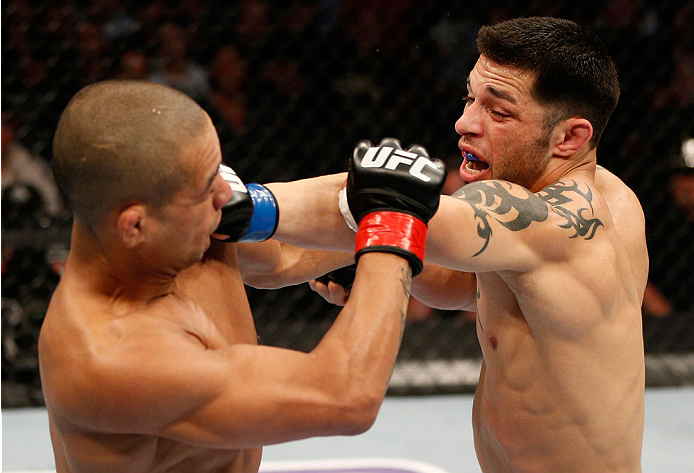 BOSTON, MA - AUGUST 17:  (R-L) Daniel Pineda punches Diego Brandao in their UFC featherweight bout at TD Garden on August 17, 2013 in Boston, Massachusetts. (Photo by Josh Hedges/Zuffa LLC/Zuffa LLC via Getty Images)