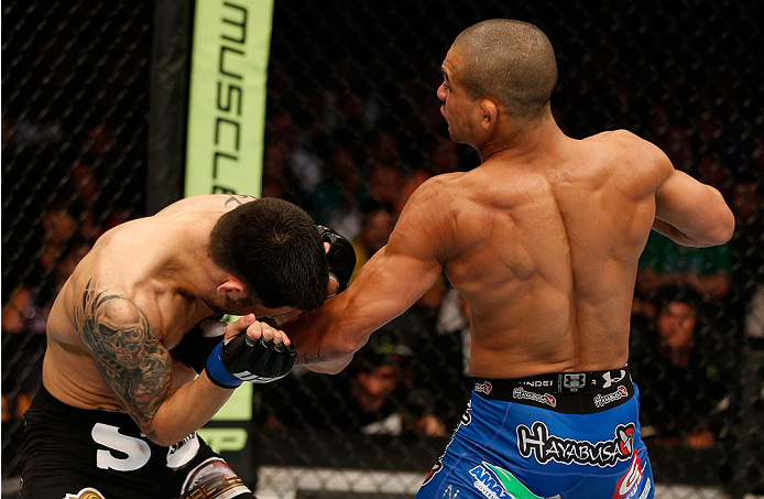 BOSTON, MA - AUGUST 17: (R-L) Diego Brandao punches Daniel Pineda in their UFC featherweight bout at TD Garden on August 17, 2013 in Boston, Massachusetts. (Photo by Josh Hedges/Zuffa LLC/Zuffa LLC via Getty Images)