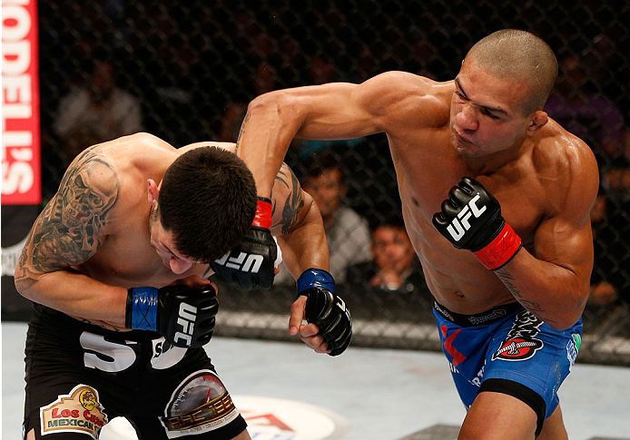 BOSTON, MA - AUGUST 17:  (R-L) Diego Brandao punches Daniel Pineda in their UFC featherweight bout at TD Garden on August 17, 2013 in Boston, Massachusetts. (Photo by Josh Hedges/Zuffa LLC/Zuffa LLC via Getty Images)