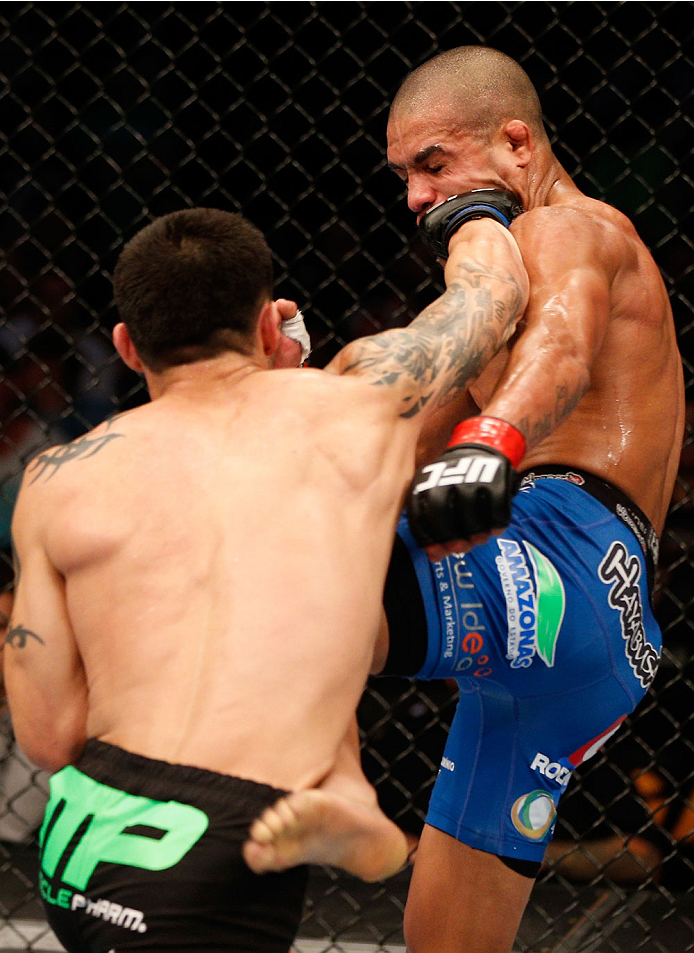 BOSTON, MA - AUGUST 17: (L-R) Daniel Pineda punches Diego Brandao in their UFC featherweight bout at TD Garden on August 17, 2013 in Boston, Massachusetts. (Photo by Josh Hedges/Zuffa LLC/Zuffa LLC via Getty Images)