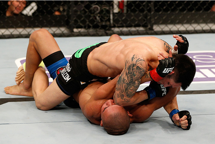 BOSTON, MA - AUGUST 17:  Daniel Pineda (top) elbows Diego Brandao in their UFC featherweight bout at TD Garden on August 17, 2013 in Boston, Massachusetts. (Photo by Josh Hedges/Zuffa LLC/Zuffa LLC via Getty Images)