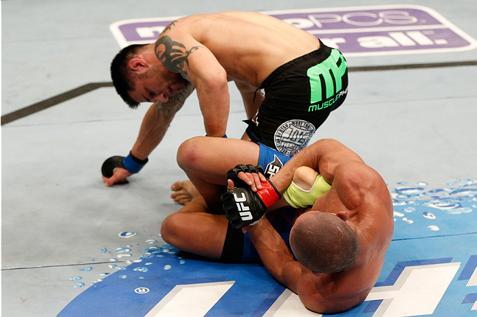 BOSTON, MA - AUGUST 17:  (R-L) Diego Brandao attempts a heel hook submission against Daniel Pineda in their UFC featherweight bout at TD Garden on August 17, 2013 in Boston, Massachusetts. (Photo by Josh Hedges/Zuffa LLC/Zuffa LLC via Getty Images)