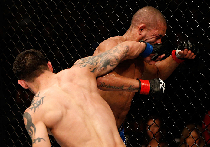 BOSTON, MA - AUGUST 17:  (L-R) Daniel Pineda punches Diego Brandao in their UFC featherweight bout at TD Garden on August 17, 2013 in Boston, Massachusetts. (Photo by Josh Hedges/Zuffa LLC/Zuffa LLC via Getty Images)