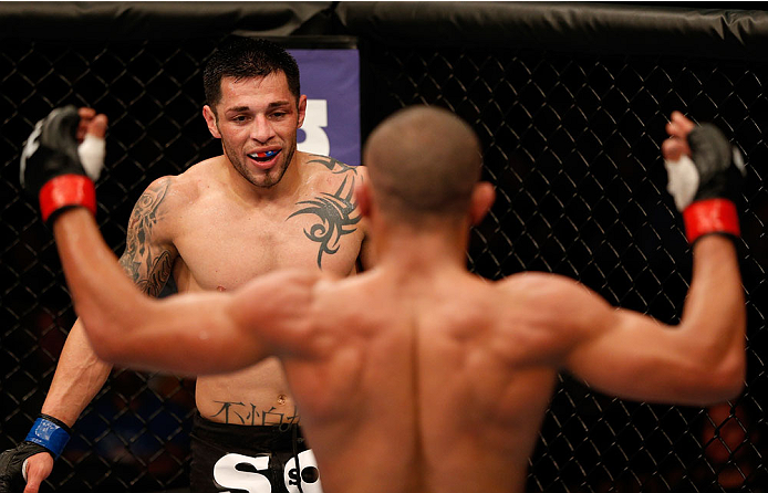 BOSTON, MA - AUGUST 17:  (L-R) Daniel Pineda looks on as Diego Brandao taunts him in their UFC featherweight bout at TD Garden on August 17, 2013 in Boston, Massachusetts. (Photo by Josh Hedges/Zuffa LLC/Zuffa LLC via Getty Images)