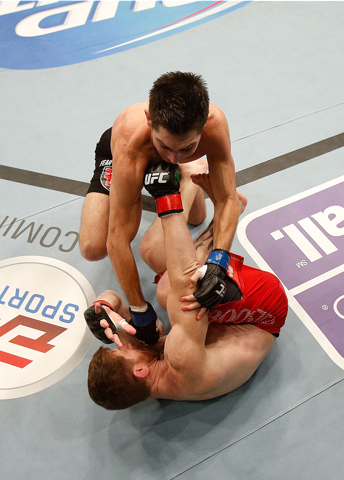 BOSTON, MA - AUGUST 17:  (L-R) Steven Siler punches Mike Brown in their UFC featherweight bout at TD Garden on August 17, 2013 in Boston, Massachusetts. (Photo by Josh Hedges/Zuffa LLC/Zuffa LLC via Getty Images)