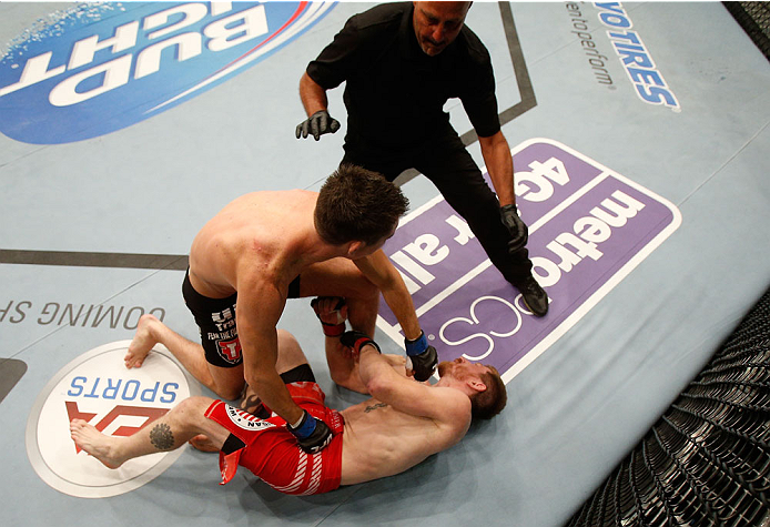 BOSTON, MA - AUGUST 17:  (L-R) Steven Siler knocks out Mike Brown with a series of punches on the ground in their UFC featherweight bout at TD Garden on August 17, 2013 in Boston, Massachusetts. (Photo by Josh Hedges/Zuffa LLC/Zuffa LLC via Getty Images)