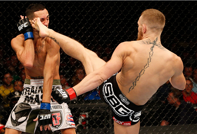 BOSTON, MA - AUGUST 17: (R-L) Conor McGregor kicks Max Holloway in their UFC featherweight bout at TD Garden on August 17, 2013 in Boston, Massachusetts. (Photo by Josh Hedges/Zuffa LLC/Zuffa LLC via Getty Images)