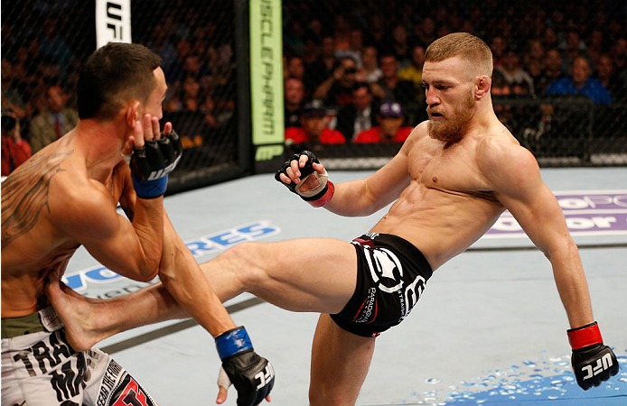 BOSTON, MA - AUGUST 17: (R-L) Conor McGregor kicks Max Holloway in their UFC featherweight bout at TD Garden on August 17, 2013 in Boston, Massachusetts. (Photo by Josh Hedges/Zuffa LLC/Zuffa LLC via Getty Images)