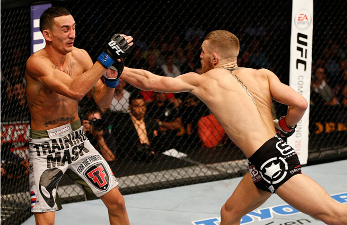 BOSTON, MA - AUGUST 17:  (R-L) Conor McGregor punches Max Holloway in their UFC featherweight bout at TD Garden on August 17, 2013 in Boston, Massachusetts. (Photo by Josh Hedges/Zuffa LLC/Zuffa LLC via Getty Images)