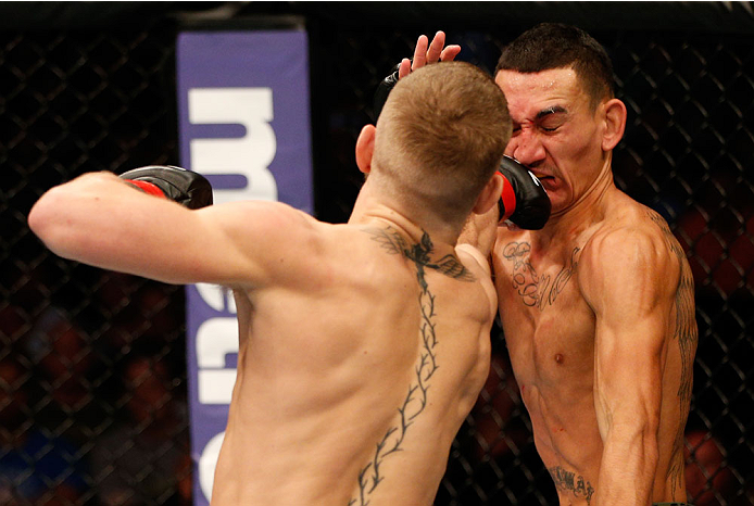 BOSTON, MA - AUGUST 17:  (L-R) Conor McGregor punches Max Holloway in their UFC featherweight bout at TD Garden on August 17, 2013 in Boston, Massachusetts. (Photo by Josh Hedges/Zuffa LLC/Zuffa LLC via Getty Images)