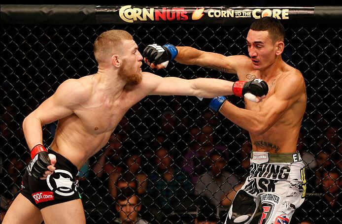 BOSTON, MA - AUGUST 17:  (L-R) Conor McGregor punches Max Holloway in their UFC featherweight bout at TD Garden on August 17, 2013 in Boston, Massachusetts. (Photo by Josh Hedges/Zuffa LLC/Zuffa LLC via Getty Images)