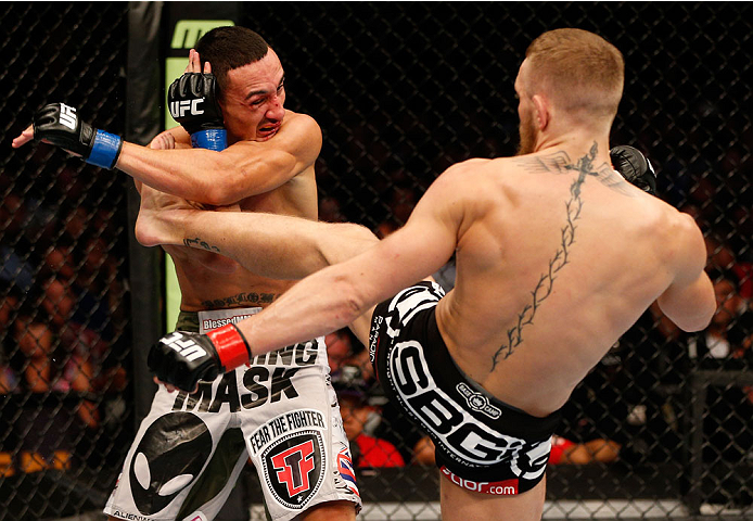 BOSTON, MA - AUGUST 17:  (R-L) Conor McGregor kicks Max Holloway in their UFC featherweight bout at TD Garden on August 17, 2013 in Boston, Massachusetts. (Photo by Josh Hedges/Zuffa LLC/Zuffa LLC via Getty Images)