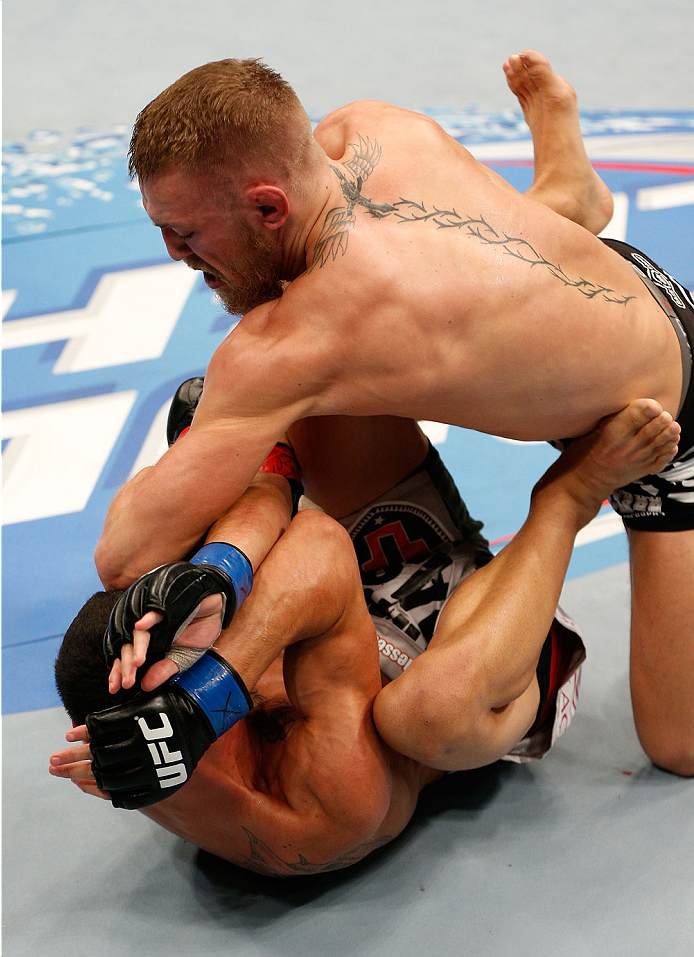 BOSTON, MA - AUGUST 17:  (R-L) Conor McGregor elbows Max Holloway in their UFC featherweight bout at TD Garden on August 17, 2013 in Boston, Massachusetts. (Photo by Josh Hedges/Zuffa LLC/Zuffa LLC via Getty Images)