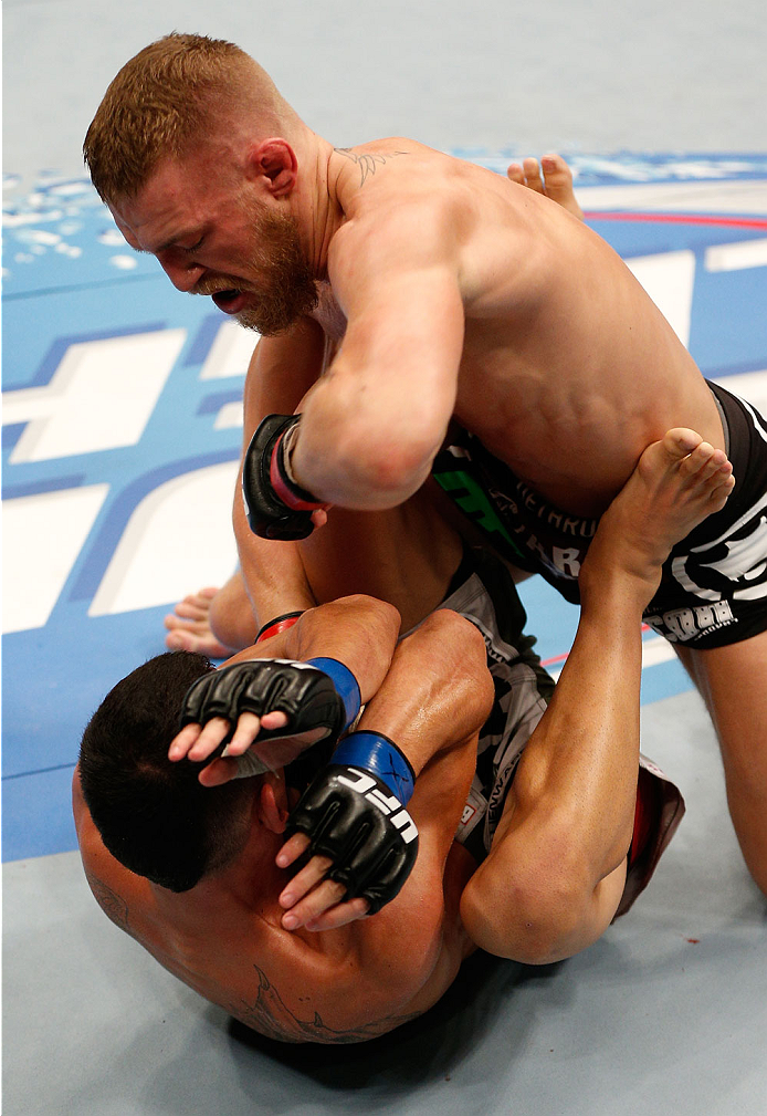 BOSTON, MA - AUGUST 17: (R-L) Conor McGregor elbows Max Holloway in their UFC featherweight bout at TD Garden on August 17, 2013 in Boston, Massachusetts. (Photo by Josh Hedges/Zuffa LLC/Zuffa LLC via Getty Images)