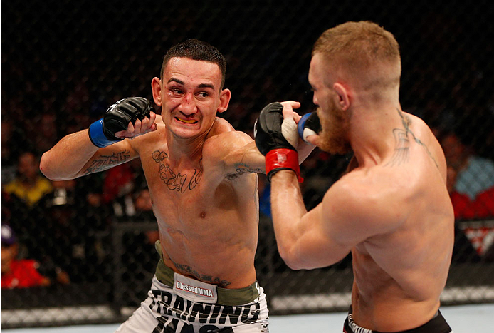 BOSTON, MA - AUGUST 17:  (L-R) Max Holloway punches Conor McGregor in their UFC featherweight bout at TD Garden on August 17, 2013 in Boston, Massachusetts. (Photo by Josh Hedges/Zuffa LLC/Zuffa LLC via Getty Images)