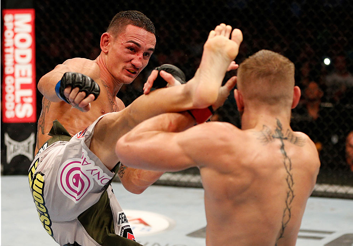 BOSTON, MA - AUGUST 17:  (L-R) Max Holloway kicks Conor McGregor in their UFC featherweight bout at TD Garden on August 17, 2013 in Boston, Massachusetts. (Photo by Josh Hedges/Zuffa LLC/Zuffa LLC via Getty Images)