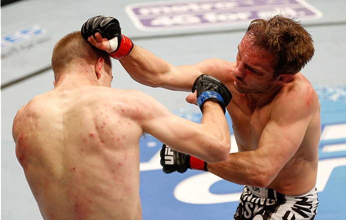 BOSTON, MA - AUGUST 17: (L-R) Michael McDonald punches Brad Pickett in their UFC bantamweight bout at TD Garden on August 17, 2013 in Boston, Massachusetts. (Photo by Josh Hedges/Zuffa LLC/Zuffa LLC via Getty Images)