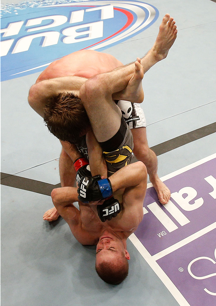 BOSTON, MA - AUGUST 17:  Michael McDonald (bottom) secures a triangle choke submission against Brad Pickett in their UFC bantamweight bout at TD Garden on August 17, 2013 in Boston, Massachusetts. (Photo by Josh Hedges/Zuffa LLC/Zuffa LLC via Getty Images