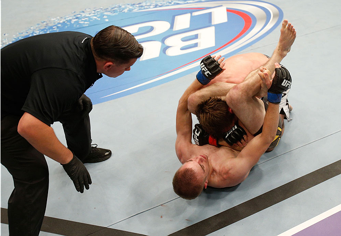 BOSTON, MA - AUGUST 17:  Michael McDonald (bottom) secures a triangle choke submission against Brad Pickett in their UFC bantamweight bout at TD Garden on August 17, 2013 in Boston, Massachusetts. (Photo by Josh Hedges/Zuffa LLC/Zuffa LLC via Getty Images