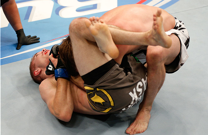 BOSTON, MA - AUGUST 17:  Michael McDonald (bottom) secures a triangle choke submission against Brad Pickett in their UFC bantamweight bout at TD Garden on August 17, 2013 in Boston, Massachusetts. (Photo by Josh Hedges/Zuffa LLC/Zuffa LLC via Getty Images