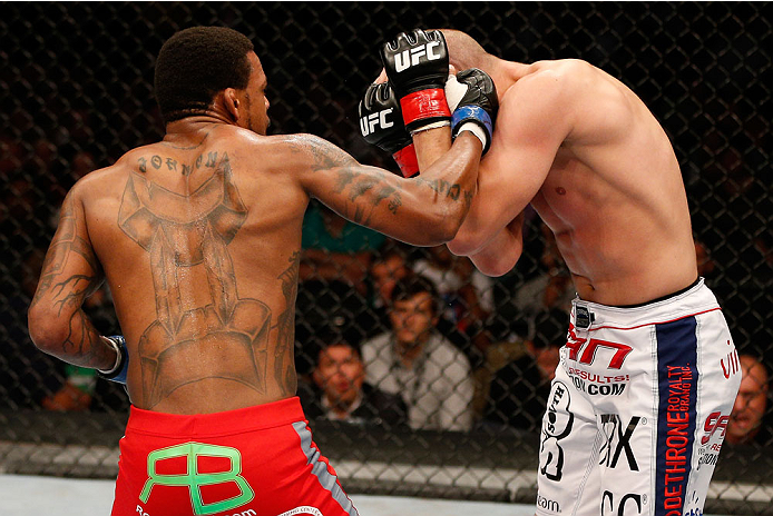 BOSTON, MA - AUGUST 17:  (L-R) Michael Johnson punches Joe Lauzon in their UFC lightweight bout at TD Garden on August 17, 2013 in Boston, Massachusetts. (Photo by Josh Hedges/Zuffa LLC/Zuffa LLC via Getty Images)