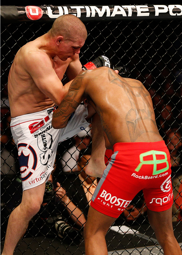 BOSTON, MA - AUGUST 17:  (L-R) Joe Lauzon knees Michael Johnson in their UFC lightweight bout at TD Garden on August 17, 2013 in Boston, Massachusetts. (Photo by Josh Hedges/Zuffa LLC/Zuffa LLC via Getty Images)