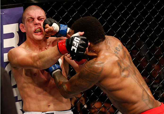 BOSTON, MA - AUGUST 17:  (R-L) Michael Johnson punches Joe Lauzon in their UFC lightweight bout at TD Garden on August 17, 2013 in Boston, Massachusetts. (Photo by Josh Hedges/Zuffa LLC/Zuffa LLC via Getty Images)