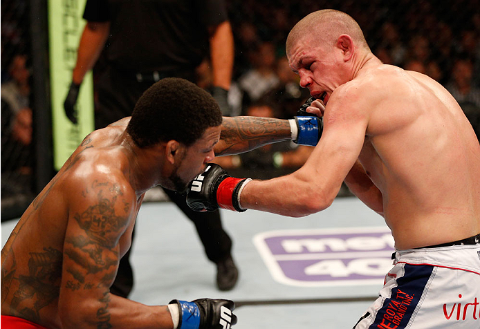 BOSTON, MA - AUGUST 17:  (L-R) Michael Johnson punches Joe Lauzon in their UFC lightweight bout at TD Garden on August 17, 2013 in Boston, Massachusetts. (Photo by Josh Hedges/Zuffa LLC/Zuffa LLC via Getty Images)