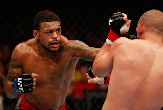 BOSTON, MA - AUGUST 17:  (L-R) Michael Johnson punches Joe Lauzon in their UFC lightweight bout at TD Garden on August 17, 2013 in Boston, Massachusetts. (Photo by Josh Hedges/Zuffa LLC/Zuffa LLC via Getty Images)