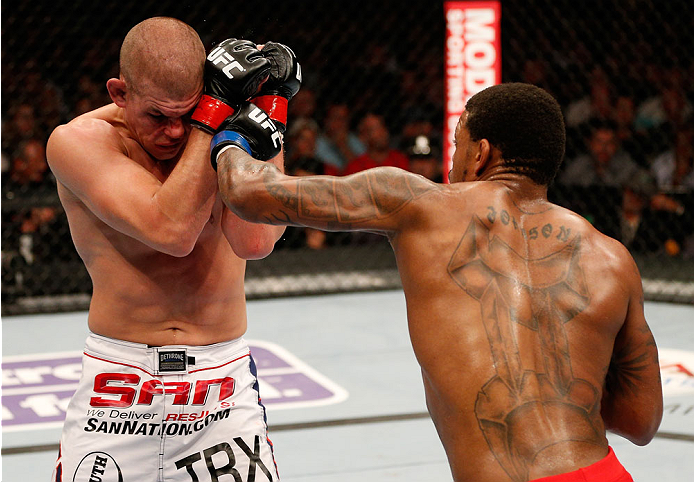 BOSTON, MA - AUGUST 17:  (R-L) Michael Johnson punches Joe Lauzon in their UFC lightweight bout at TD Garden on August 17, 2013 in Boston, Massachusetts. (Photo by Josh Hedges/Zuffa LLC/Zuffa LLC via Getty Images)