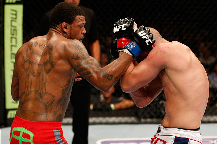 BOSTON, MA - AUGUST 17:  (L-R) Michael Johnson punches Joe Lauzon in their UFC lightweight bout at TD Garden on August 17, 2013 in Boston, Massachusetts. (Photo by Josh Hedges/Zuffa LLC/Zuffa LLC via Getty Images)