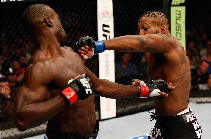 BOSTON, MA - AUGUST 17:  (R-L) John Howard punches Uriah Hall in their UFC middleweight bout at TD Garden on August 17, 2013 in Boston, Massachusetts. (Photo by Josh Hedges/Zuffa LLC/Zuffa LLC via Getty Images)