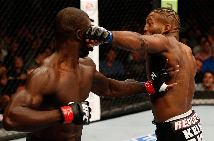 BOSTON, MA - AUGUST 17:  (R-L) John Howard punches Uriah Hall in their UFC middleweight bout at TD Garden on August 17, 2013 in Boston, Massachusetts. (Photo by Josh Hedges/Zuffa LLC/Zuffa LLC via Getty Images)